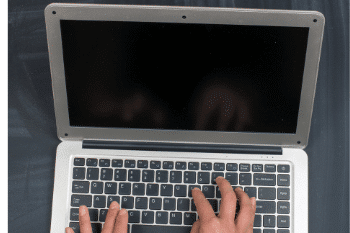 hands on a laptop keyboard