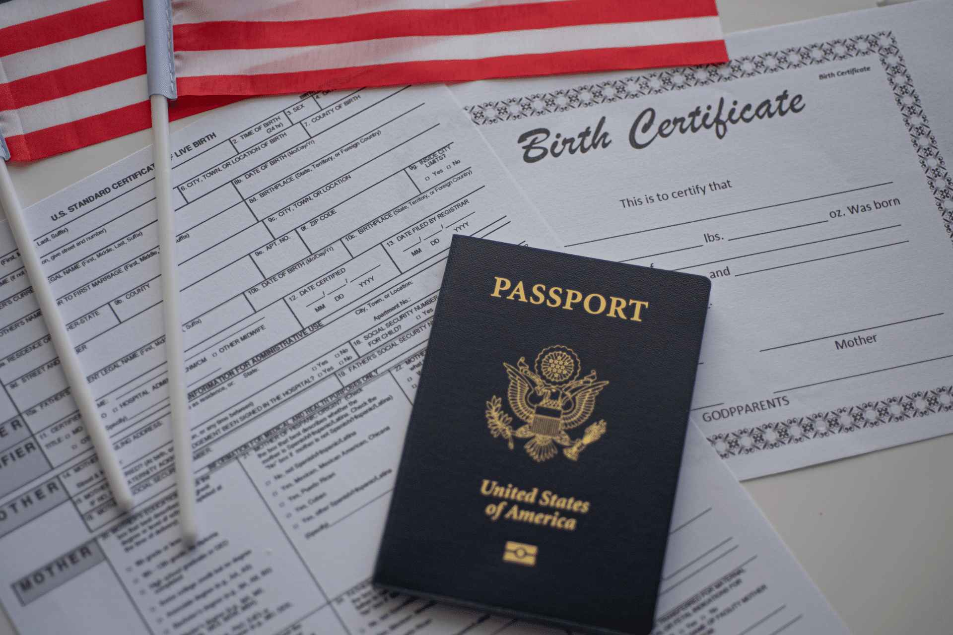 us passport on a desk with a copy of a birth certificate