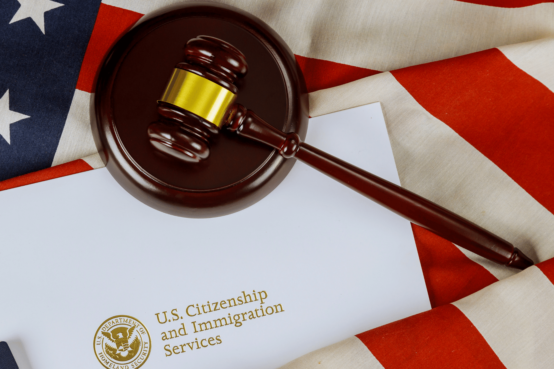 gavel and US Citizenship and Immigration Services logo on a U.S. flag