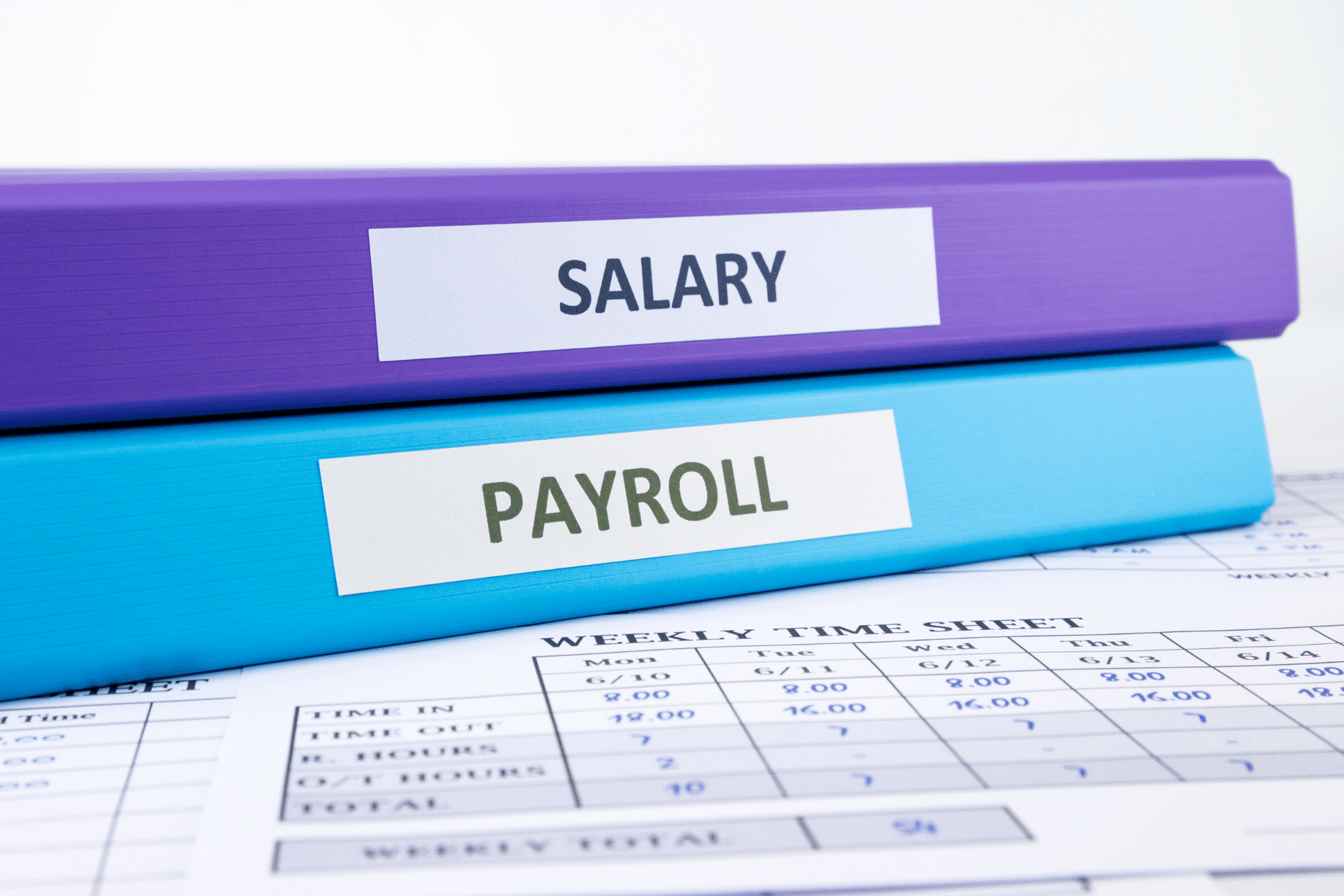 payroll and salary binders on a desk